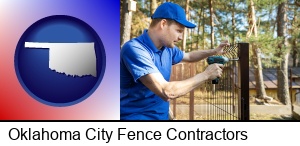 Oklahoma City, Oklahoma - fence builder attaching fencing to a fence post