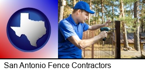 San Antonio, Texas - fence builder attaching fencing to a fence post
