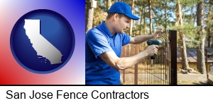San Jose, California - fence builder attaching fencing to a fence post