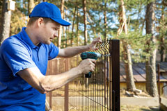 fence builder attaching fencing to a fence post